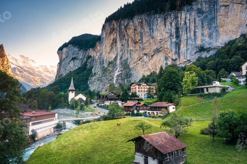 Preview: View of Lauterbrunnen valley with rustic village, famous church and Staubbach falls
