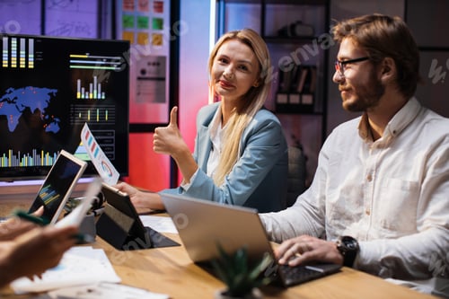 Preview: Motivated office workers using modern gadgets while sitting at desk
