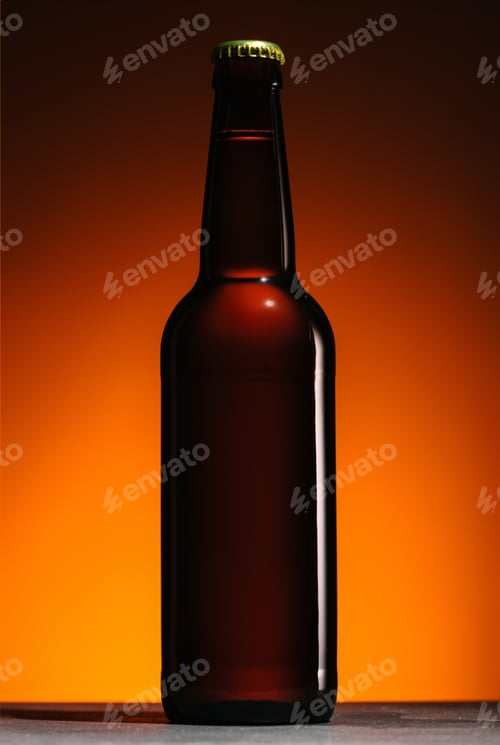 Preview: close up view of beer bottle on orange background