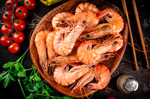 Preview: Boiled shrimp on a plate with tomatoes and parsley.