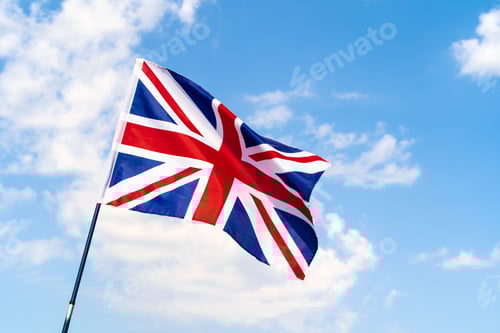 Preview: United Kingdom Flag waving on wind in blue sky