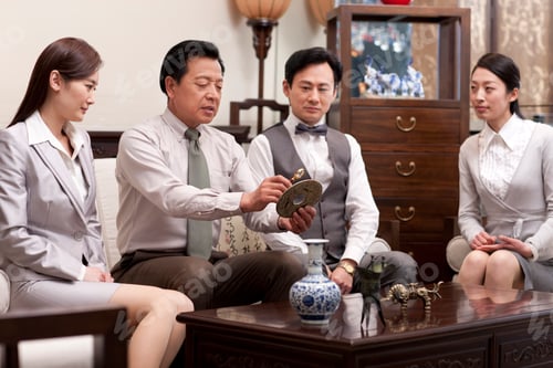 Preview: Business people admiring antiques