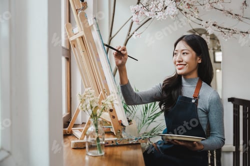 Preview: Female artist painting on canvas with brush Young painter working on the floor of her art studio cre