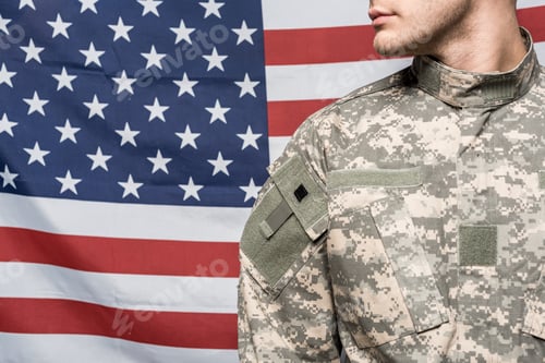 Preview: cropped view of man in military uniform near flag of america