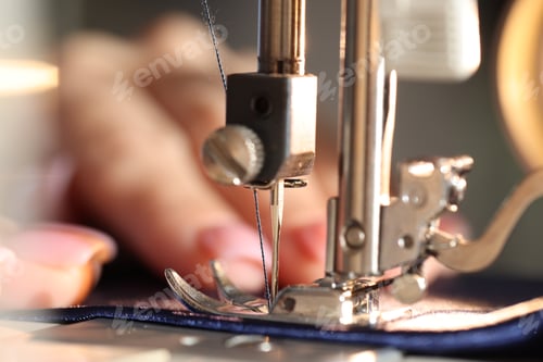 Preview: Woman working with sewing machine, macro view