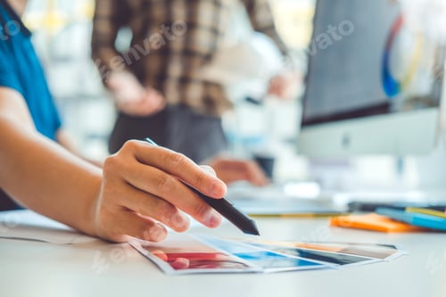 Preview: Graphic designer Brainstorming Meeting and drawing on graphics tablet at workplace