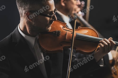 Preview: Man Plays Violin at Orchestra Performance