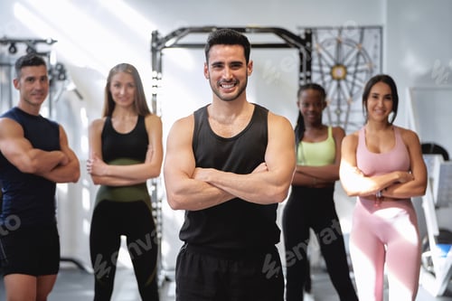 Preview: group of fitness and multi-ethnic people posing for the camera with their arms crossed