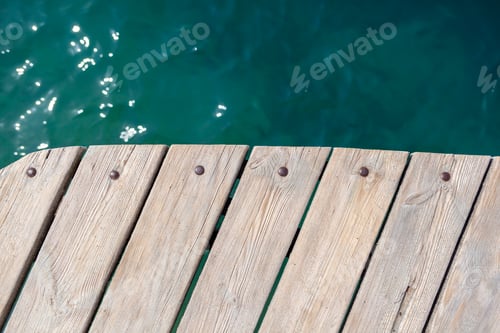 Preview: Wooden planks on the pier above the blue sea. top of the water.