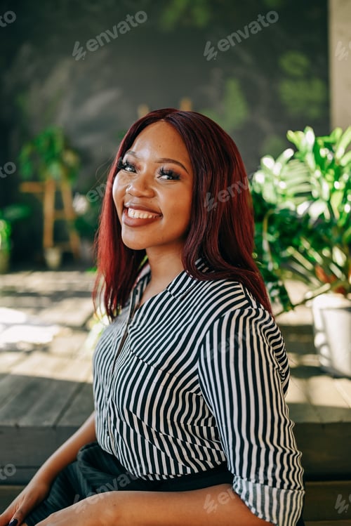 Preview: Beautiful young black woman red hair lifestyle portrait indoors in room green house plants