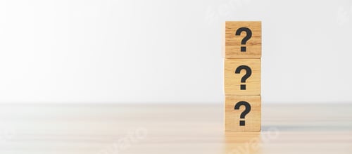 Preview: Questions Mark word with wood block on table background.
