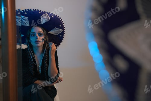 Preview: Portrait of woman in Mexican day of dead makeup front a mirror