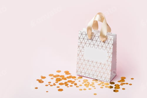 Preview: White Geometric shopping bag and trendy hexagonal sparkles on pink background. Holiday sale concept