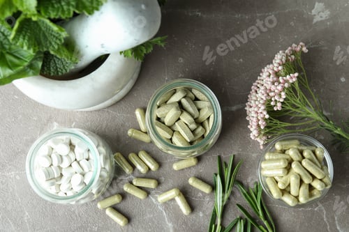 Preview: Concept of herbal medicine pills on gray textured background