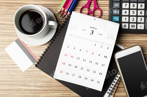 Preview: Workspace setup with calendar, coffee, and study materials on a wooden desk