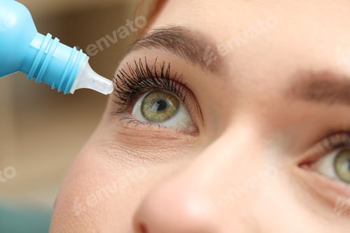 Preview: Woman applying medical eye drops, macro view