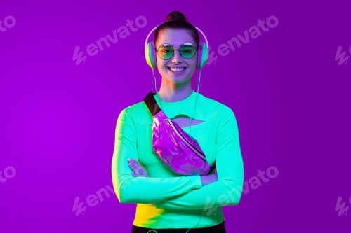 Preview: Young smiling girl standing with crossed arms