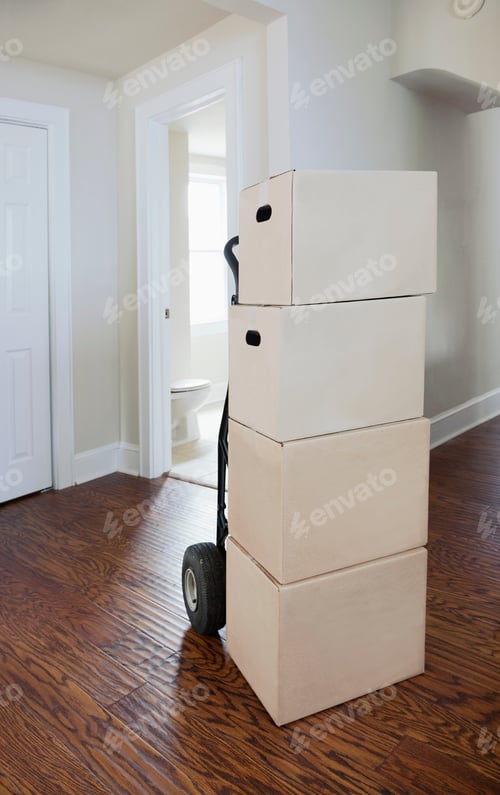 Preview: Moving house, relocation, cardboard boxes piled up in a house