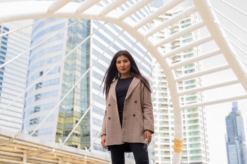 Preview: Young beautiful Indian businesswoman at the skywalk bridge