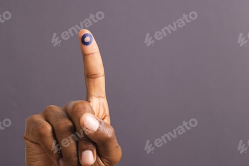 Preview: Hand of biracial man with blue ring on outstretched finger, on grey background with copy space