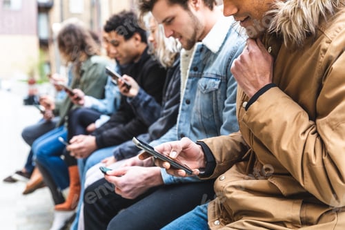 Preview: Multicultural group of friends using smartphone and having fun