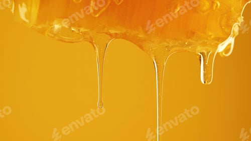 Preview: Honey dripping from honeycombs extreme macro.Natural bees wax cells, gold elixir