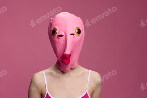 Preview: Conceptual art photo of a sexy woman in a fish mask for Halloween on a pink background