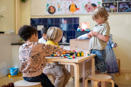 Preview: Young children in school concentrating on their lesson. Learning about colours, shapes and writing