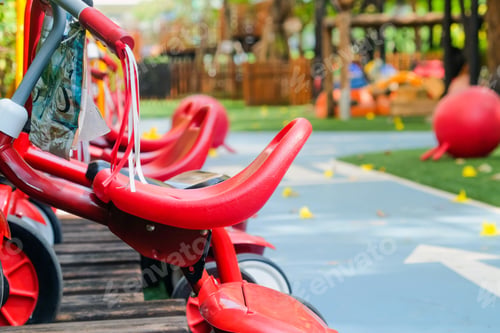 Preview: Children's playground in public park, close up of red chairs.
