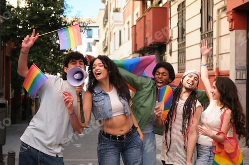 Preview: Young activists protesting for lgbt rights waving rainbow flags and shouting through megaphone