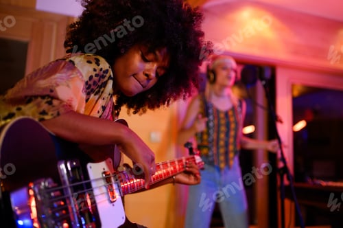 Preview: A multiracial bass player improvising and jamming in a music studio, recording session.