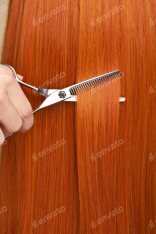 Preview: Hairdresser cuts long red hair with scissors