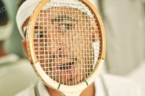 Preview: Shot of a young man pressing his face up against his squash racket