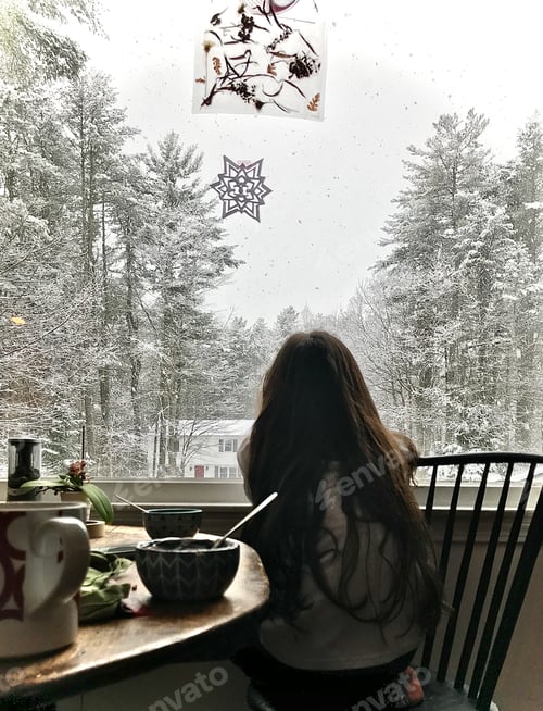 Preview: Child Enjoying Snowy View from Cozy Home