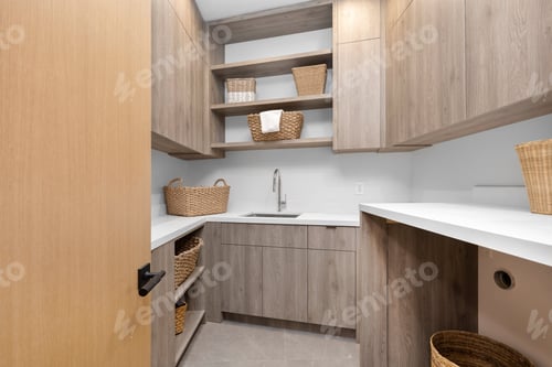 Preview: Small laundry room with beige furniture and white floor.