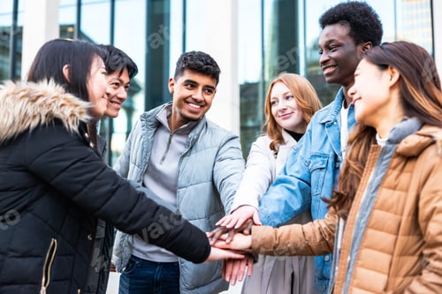 Preview: Multiracial friends putting hands on stack and enjoying teamwork