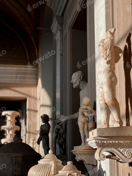 Preview: Vertical photograph of multiple ancient statues standing against a bright background