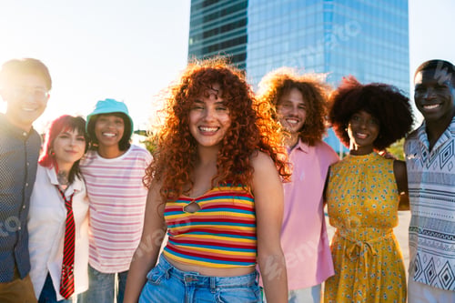 Preview: Multiethnic group of young friends meeting and having fun outdoors