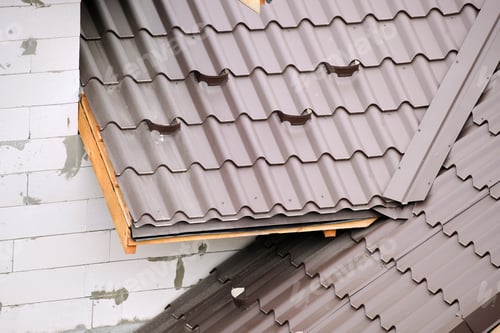 Preview: Closeup snow guard for safety in winter on house roof top covered with steel shingles. Tiled