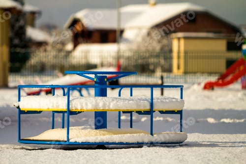 Preview: Playground in kindergarten for children in winter with snow covered swings