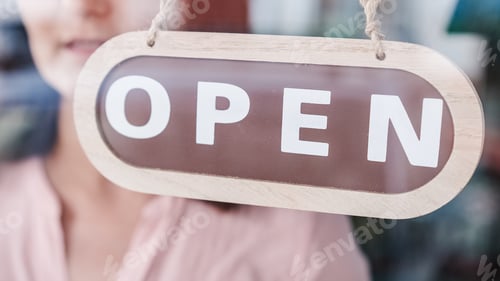 Preview: Small business opening up. Turning the sign from close to open. Unrecognizable person