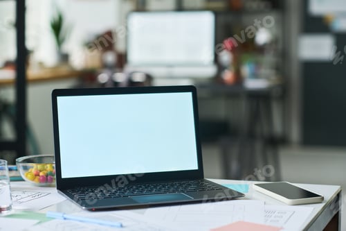 Preview: Modern Laptop with Blank Screen Standing on Desk in Contemporary Office