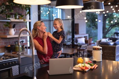 Vista previa: Caucasian woman spending time in the kitchen with her daughter