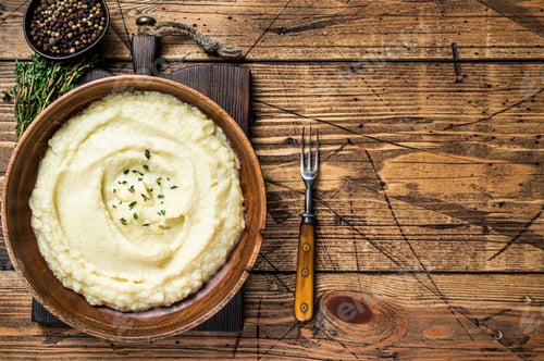 Preview: Mashed potatoes, boiled puree in a wooden plate. Wooden background. Top view. Copy space