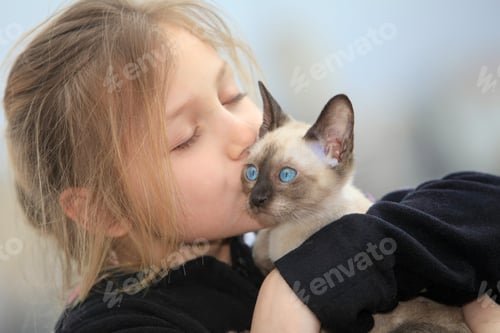 Preview: Young Girl Holding Kitten Outdoors