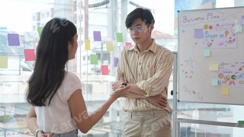 Preview: Professional male manager listening attentively to his colleague during discussing new project.