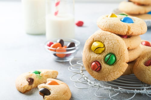 Preview: Homemade cookies with colorful chocolate candies and milk. Stack of shortbread cookies with multi co