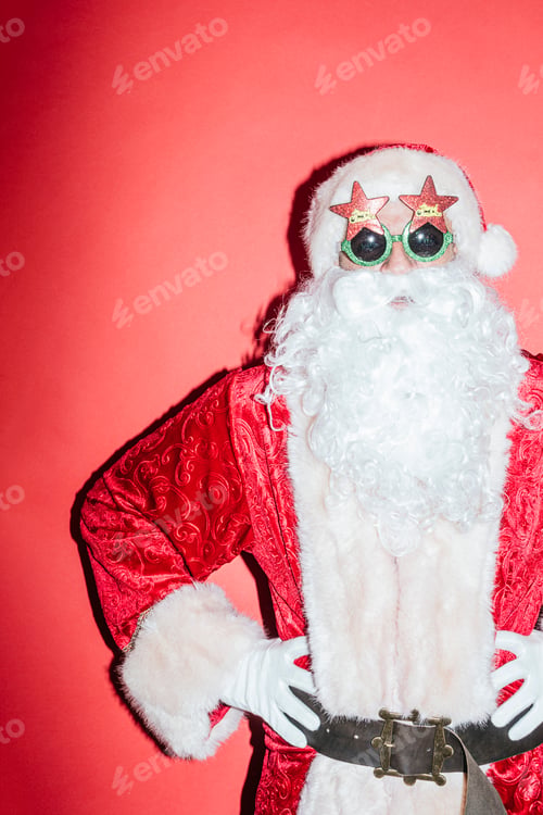 Preview: Man dressed as Santa Claus gesturing with funny glasses