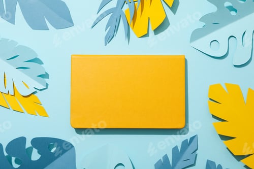 Preview: Yellow and blue tropical leaves in pastel shades on a blue background