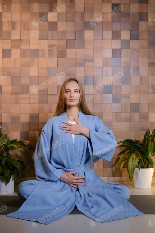 Preview: Girl in blue kimano practicing kundalini or qigong yoga in fitness gym . Spiritual energy, life